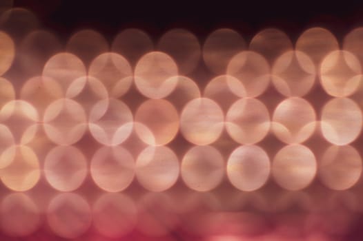 Abstract colorful bokeh defocused lights in pattern of straight rows. holiday background