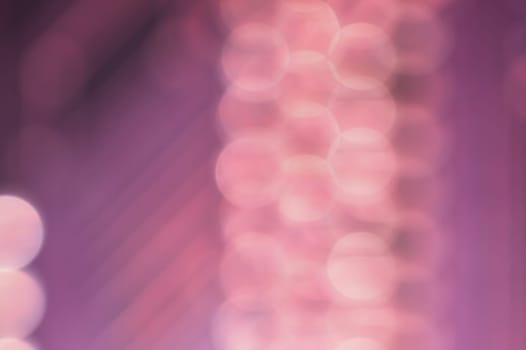 Abstract colorful bokeh defocused lights in pattern of straight rows. holiday background