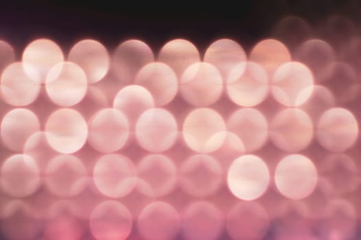 Abstract colorful bokeh defocused lights in pattern of straight rows. holiday background