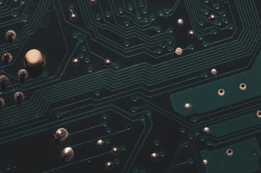Dusty circuit board. computer motherboard close up. modern technologies. micro elements of computer with connections and traces. Intelligent technology abstract background