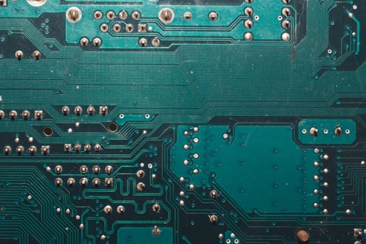 Dusty circuit board. computer motherboard close up. modern technologies. micro elements of computer with connections and traces. Intelligent technology abstract background