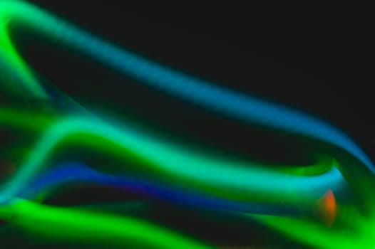 Colorful light traces with long exposure in the dark. abstract blurred lights background
