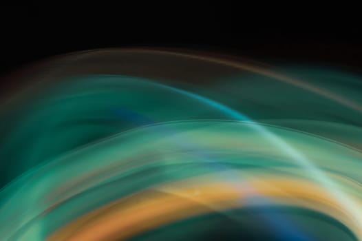 Colorful light traces with long exposure in the dark. abstract blurred lights background
