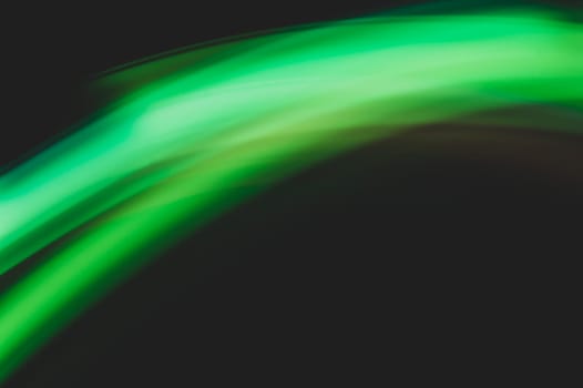 Colorful light traces with long exposure in the dark. abstract blurred lights background