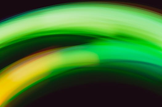 Colorful light traces with long exposure in the dark. abstract blurred lights background