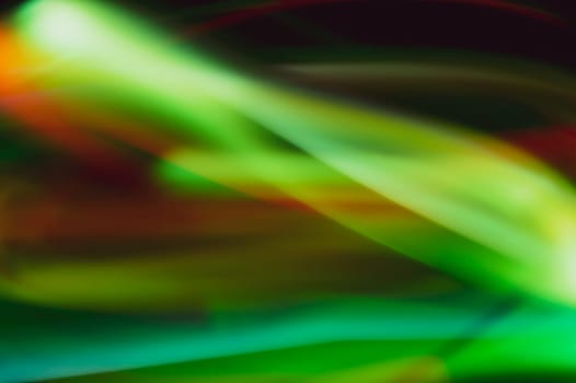 Colorful light traces with long exposure in the dark. abstract blurred lights background