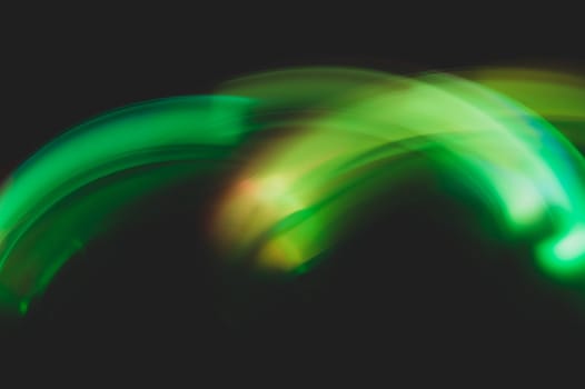 Colorful light traces with long exposure in the dark. abstract blurred lights background