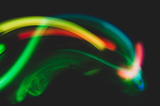 Colorful light traces with long exposure in the dark. abstract blurred lights background