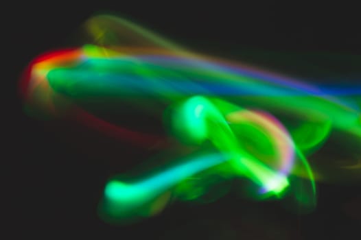 Colorful light traces with long exposure in the dark. abstract blurred lights background