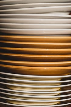 Stack of white and brown dishes background. kitchen utensils