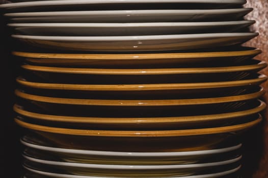 Stack of white and brown dishes background. kitchen utensils