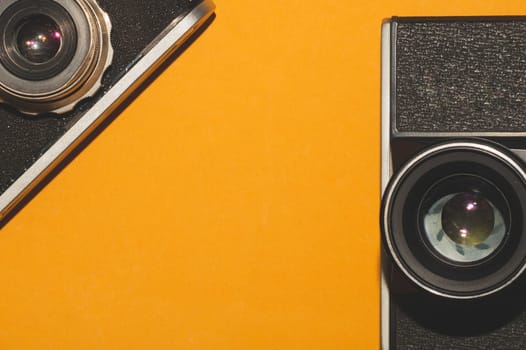 Vintage cameras on yellow background. copy space