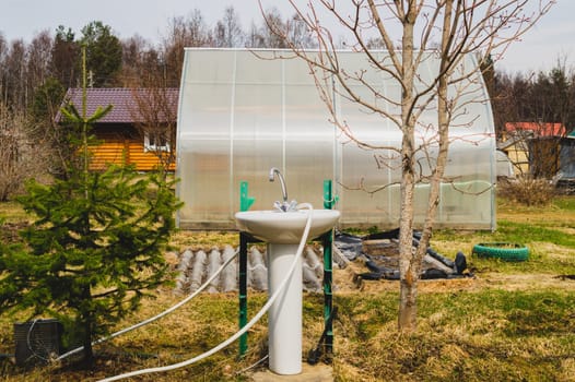 Sink and faucet in the garden. water tap outside the house. backyard of the summer house. closer to nature concept