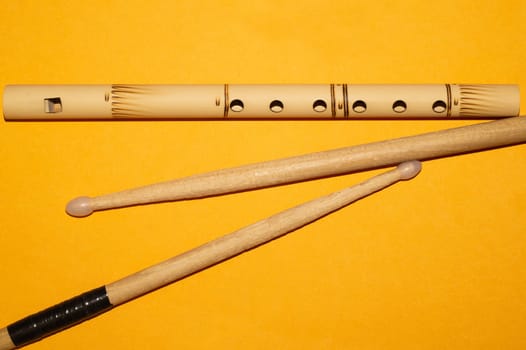 Bamboo bansuri flute and drumsticks. simple music instruments