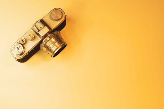 Vintage camera on yellow background. copy space