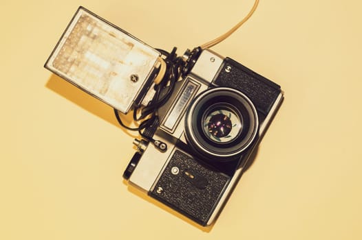 Vintage camera on yellow background. copy space