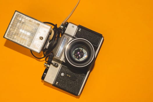 Vintage camera on yellow background. copy space