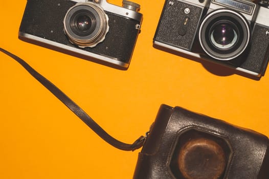 Vintage cameras on yellow background. copy space