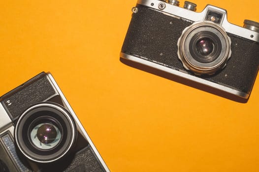 Vintage cameras on yellow background. copy space