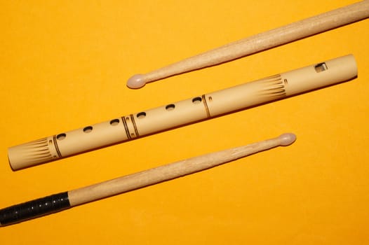 Bamboo bansuri flute and drumsticks. simple music instruments