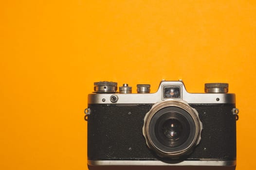 Vintage camera on yellow background. copy space