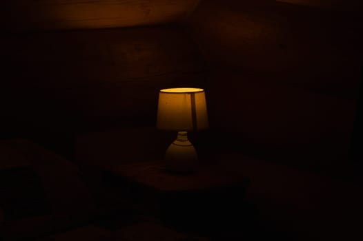 Luminous desk lamp with lampshade in the dark