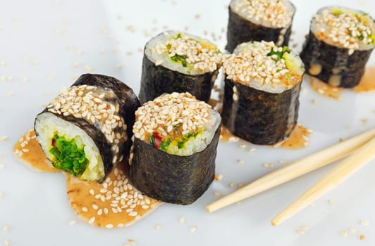 Traditional japanese sush with two Chopsticks isolated on white background