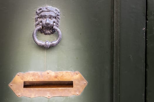 Old wooden door with knocker and letter box