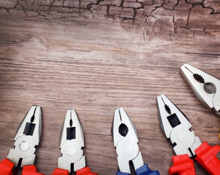 copyspace image set of handtools pliers on vintage wooden board construction concept