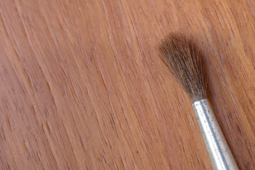 Brush tip on a wooden background