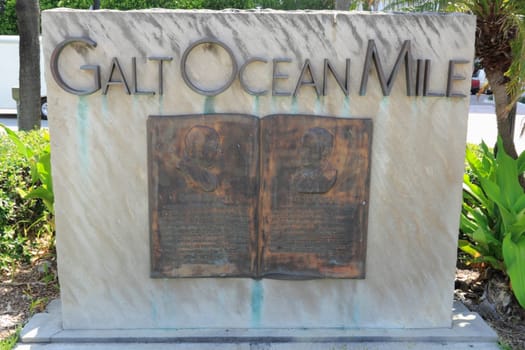 FORT LAUDERDALE, FL, USA - APRIL 7, 2014: Galt Ocean Mile neighborhood name entry sign closeup in copper metal on flat stone.  Featured on this upright tablet sculpture below are profiles of Robert H. Gore and M.A. Hortt with historic information.