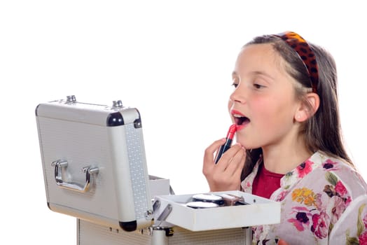 a little girl puts makeup of his mother on white