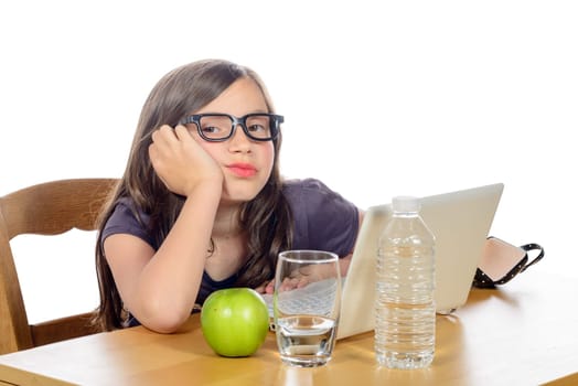 a tired little girl with her computer and an apple