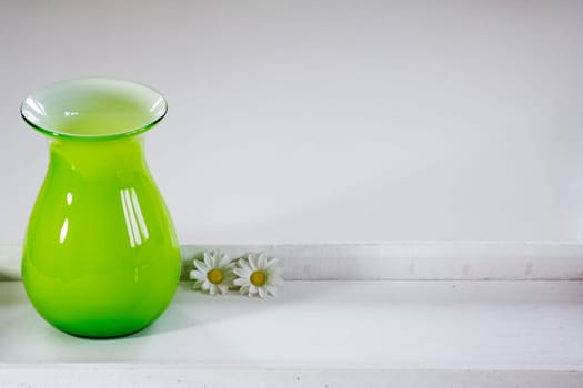 Green vase on a white tray