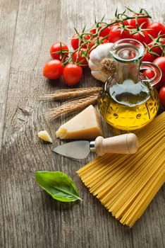Spaghetti and tomatoes with parmesan cheese on a vintage wooden table