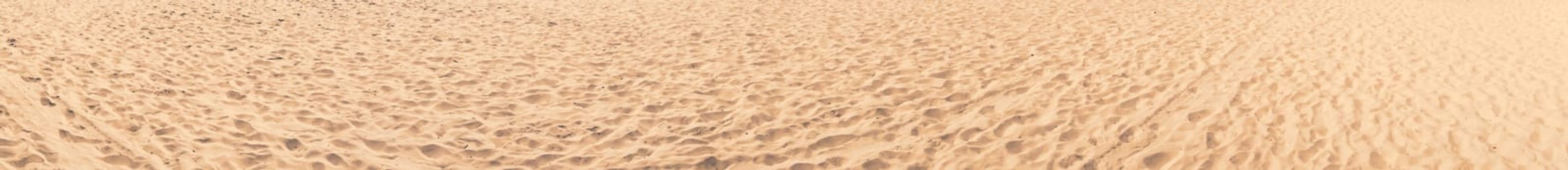 Sand on the beach wide and long panorama for banner