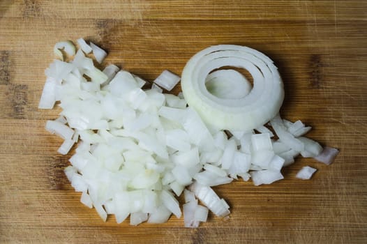 White onion on a wooden cutting board. vegetable slicing process. cooking food