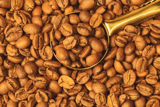 Coffee beans and spoon. roasted coffee beans macro background