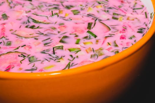 Cold beet soup close up. vegetable soup with beetroot and greens