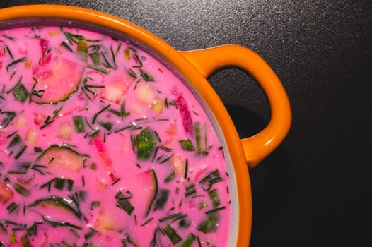 Cold beet soup close up. vegetable soup with beetroot and greens