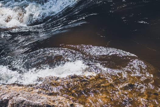 Water stream with foam. falling river water. waterfall flow. water background