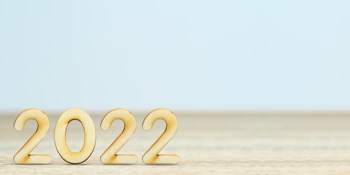 Wooden numeric new year 2022 on table with copy space