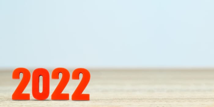 Shot of a number 2022 made of red plastic new year on table with copy space