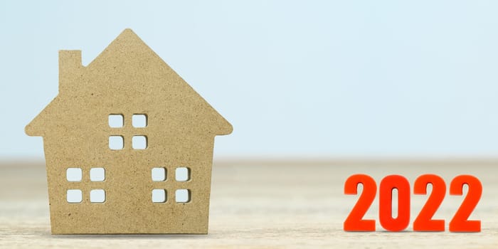House model and number 2022 on table for finance and banking concept with copy space
