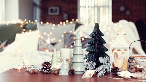 Christmas or New Year composition with various home decorations, different symbolic toys composed and ordered at coffee table with blurred Christmas lights background at sofa white cover. Family time