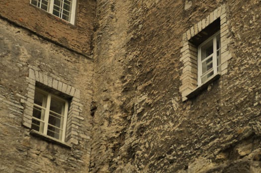 Old brown brick wall with windows background