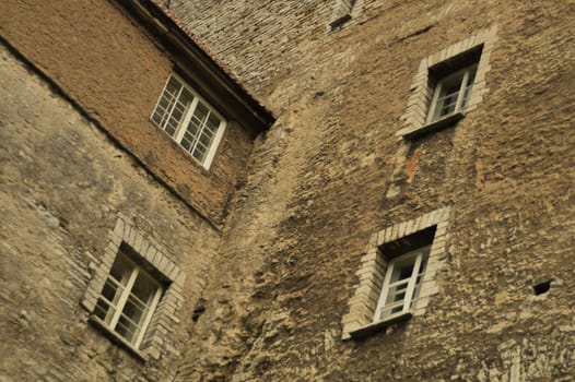 Old brown brick wall with windows background