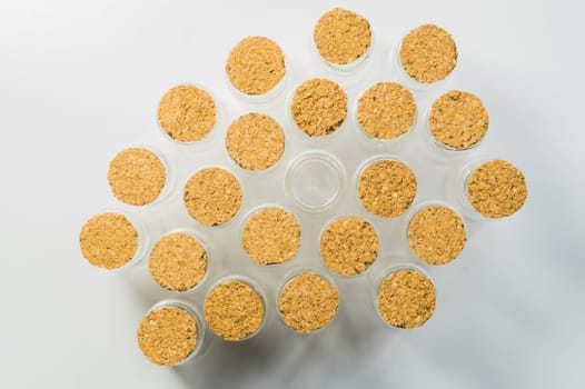 Empty little bottles with cork stopper isolated on white. glass vessels. transparent containers. test tubes