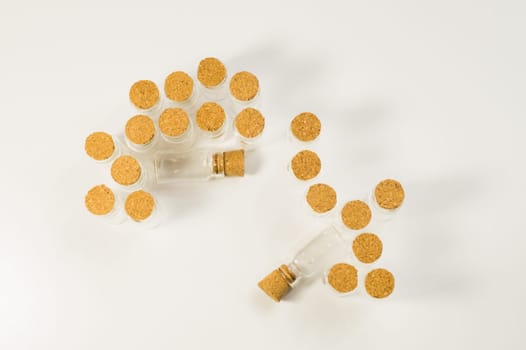 Empty little bottles with cork stopper isolated on white. glass vessels. transparent containers. test tubes. copy space