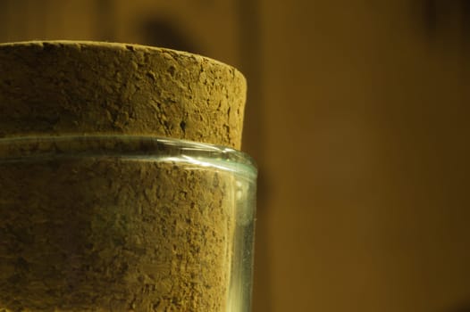 Big cork in the glass bottle close up background